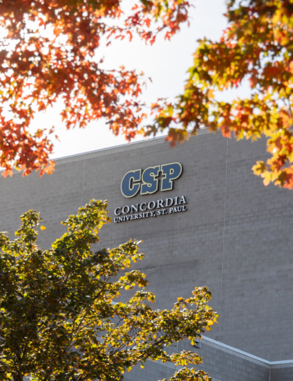 Gray building with CSP sign on it in autumn